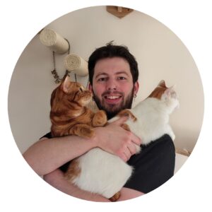 Vrijwilliger Thomas met twee katten in z'n armen